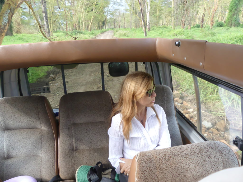 Jenny Ludwig in safari van with pop-up roof near Lake Nakuru National Park, Kenya 